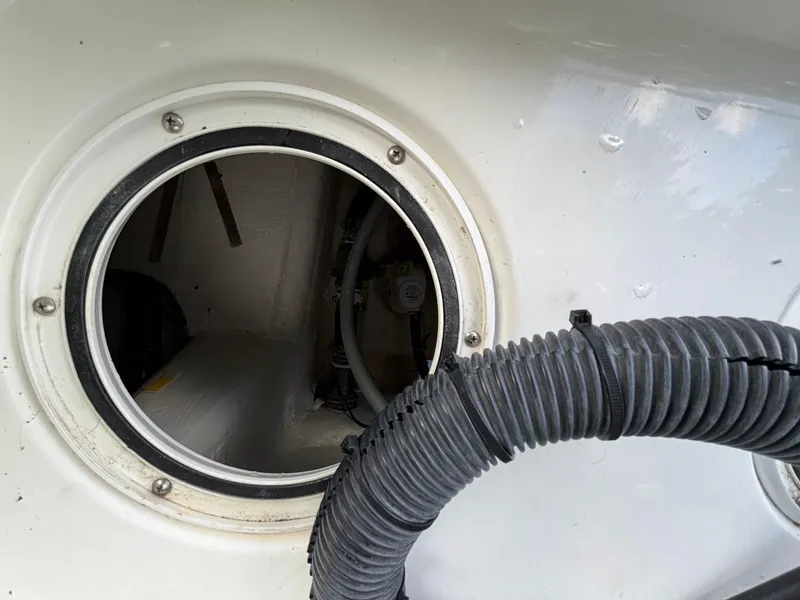 Slide: The Image of Inspection hatch of a 2004 Triton LTS boat with visible tubing and interior components. - 15