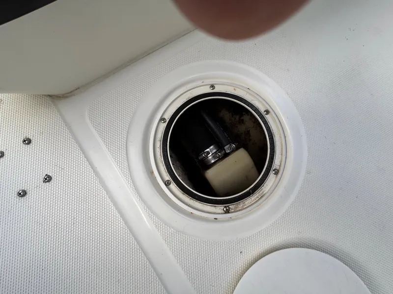 Slide: The Image of Boat hatch with visible pump inside, Triton LTS 2004 model. - 19