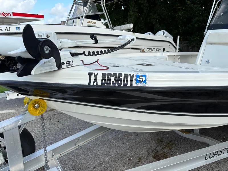 Slide: The Image of 2004 Triton LTS boat on trailer with registration number TX 8636 DY. - 21