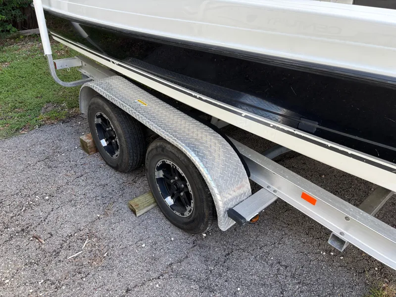 Slide: The Image of 2004 Triton LTS boat trailer with dual wheels on a paved surface. - 24