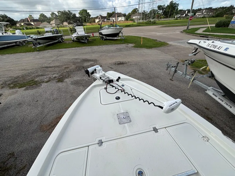 Slide: The Image of 2004 Triton LTS boat with trolling motor, parked on a trailer in a lot. - 9