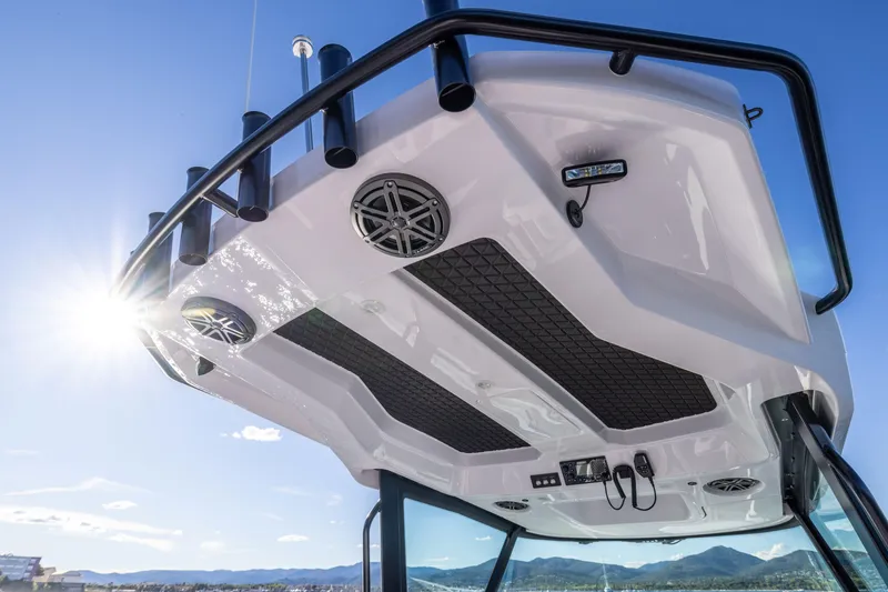 Slide: The Image of 2026 Axopar AX29 CCX boat cruising on calm blue waters. - 11