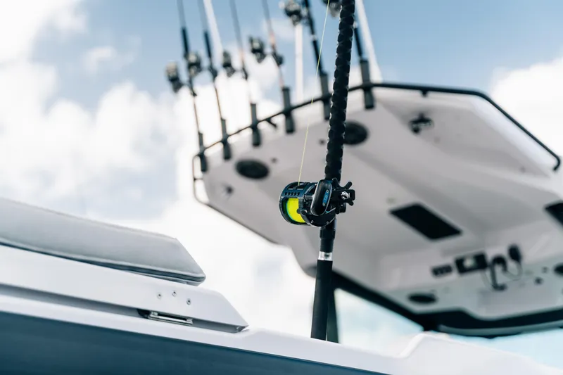 Slide: The Image of 2026 Axopar AX29 CCX boat cruising on calm waters near a marina. - 12