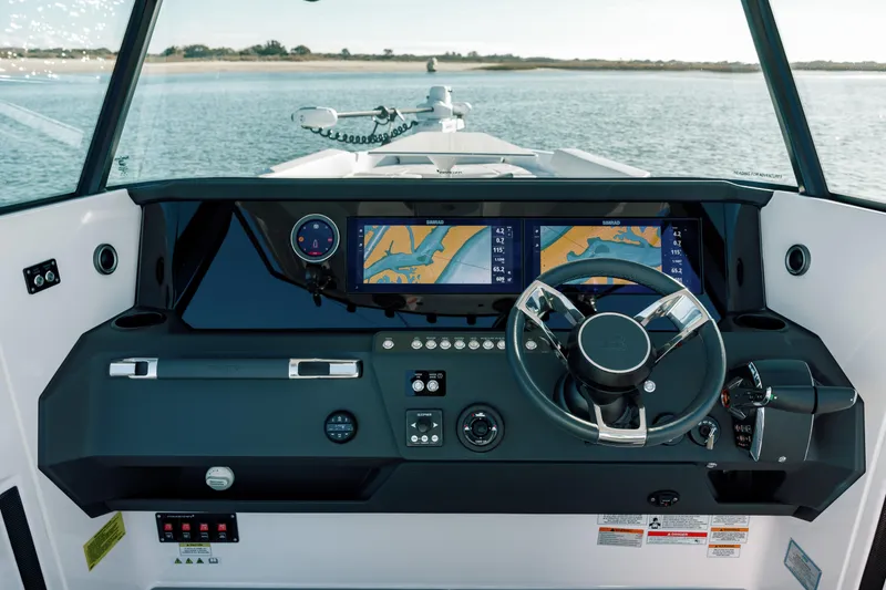 Slide: The Image of 2026 Axopar AX29 CCX boat cruising on calm blue waters. - 15