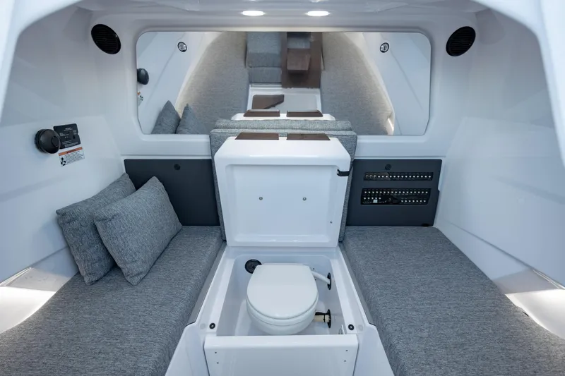 Slide: The Image of 2026 Axopar AX29 CCX boat on calm water, featuring sleek seating and modern design. - 18