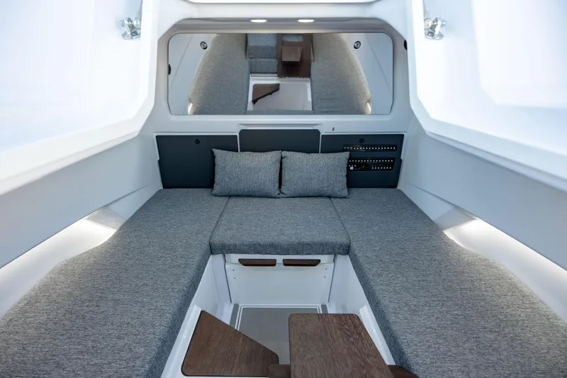 Slide: The Image of 2026 Axopar AX29 CCX boat with seating, American flag, and ocean view. - 19