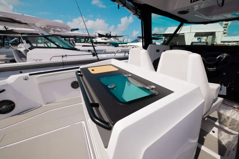 Slide: The Image of 2026 Axopar AX29 CCX boat on water with city skyline in background. - 21