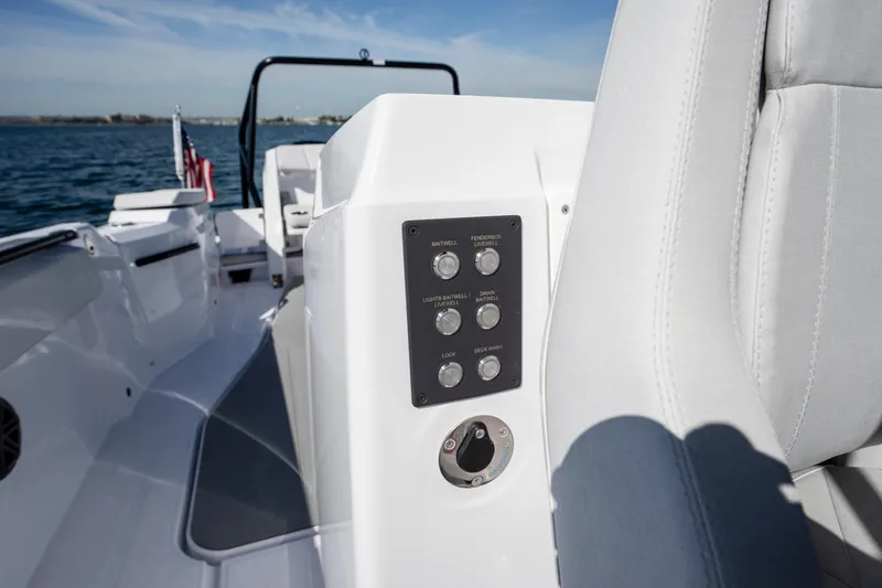 Slide: The Image of 2026 Axopar AX29 CCX boat interior with control panel, sleek design, and ocean backdrop. - 28