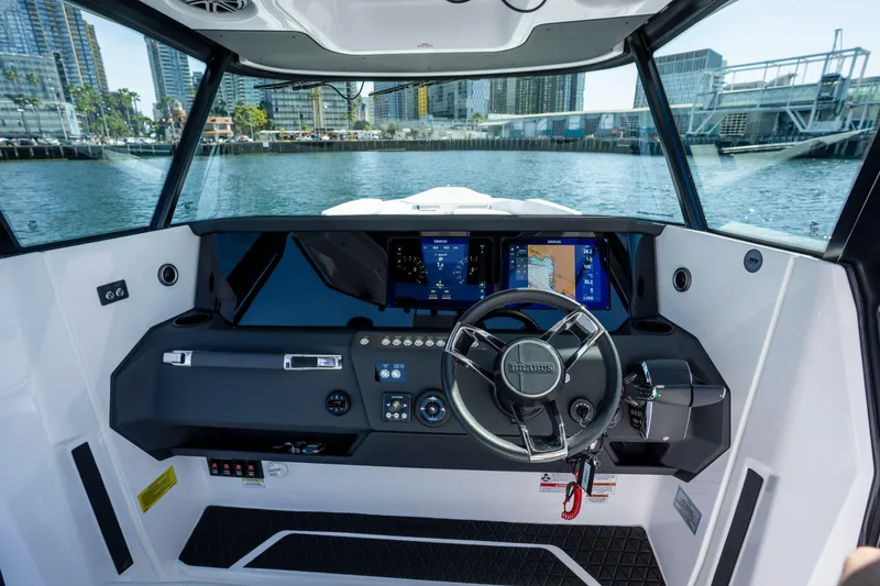 Slide: The Image of 2026 Axopar AX29 CCX boat cockpit with modern navigation displays and steering wheel. - 29