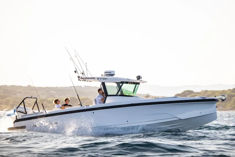 Slide: The Image of 2026 Axopar AX29 CCX cruising near city skyline on a sunny day. - 3