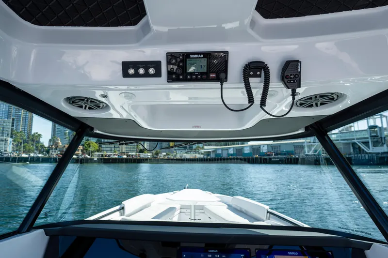 Slide: The Image of Interior view of 2026 Axopar AX29 CCX boat with modern controls and waterfront backdrop. - 30