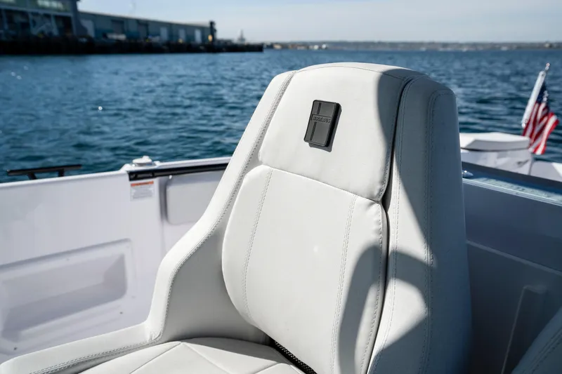 Slide: The Image of 2026 Axopar AX29 CCX boat seat with ocean view and American flag. - 35