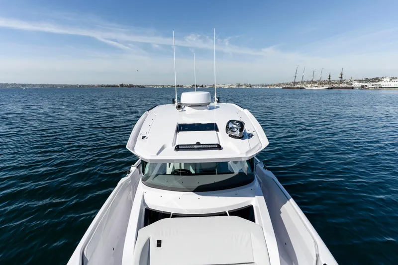 Slide: The Image of 2026 Axopar AX29 CCX boat on calm blue water, clear sky background. - 40