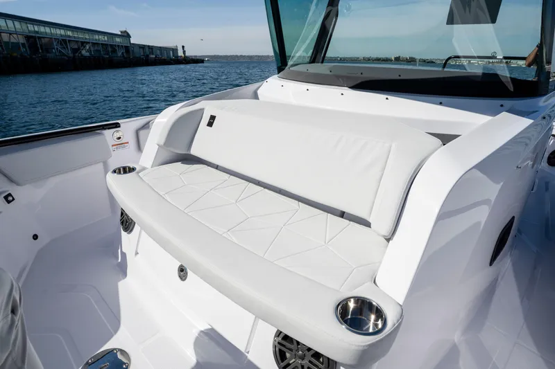 Slide: The Image of 2026 Axopar AX29 CCX boat with sleek white seating and cup holders on deck. - 41