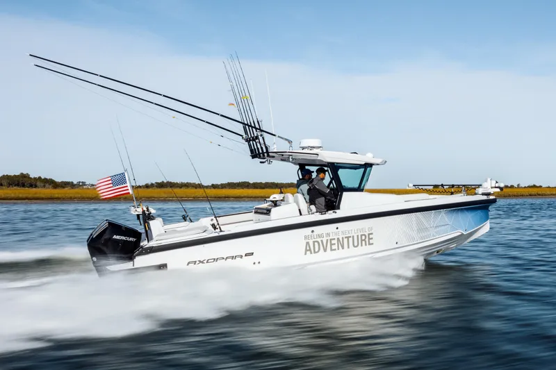 Slide: The Image of 2026 Axopar AX29 CCX cruising in urban waterfront setting. - 8