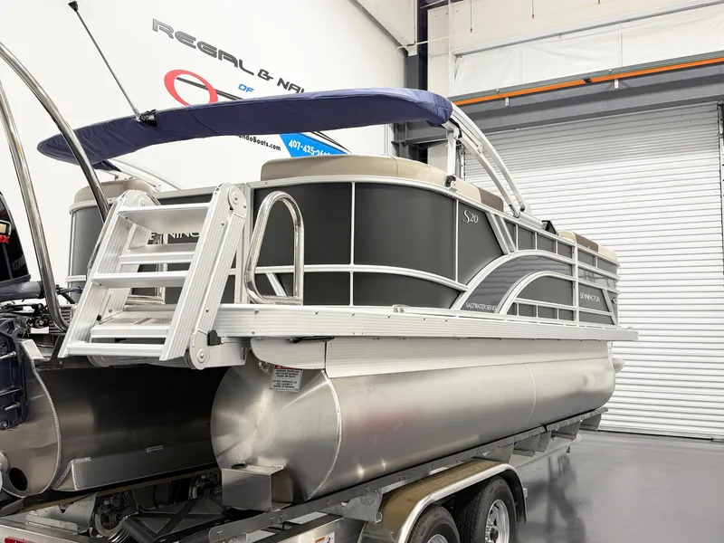 Slide: The Image of 2025 Bennington 20 S STERN RADIUS pontoon boat on trailer in showroom. - 2