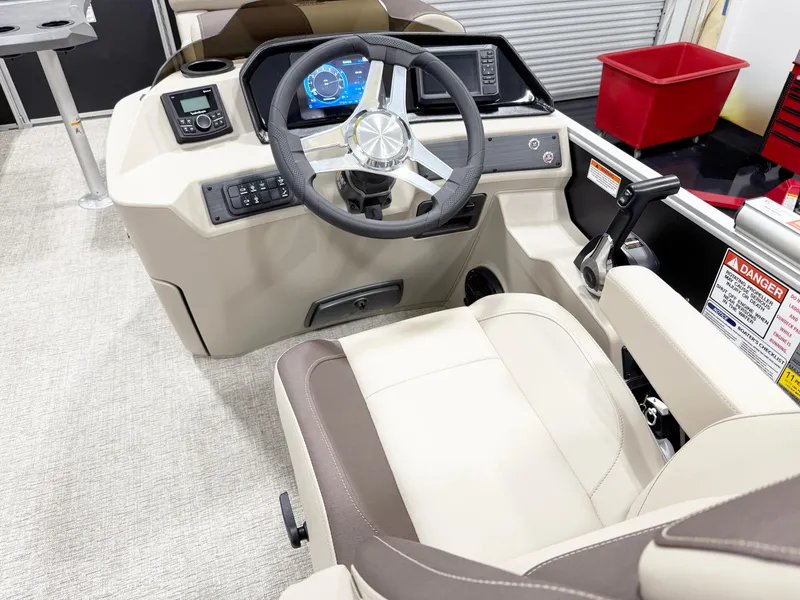 Slide: The Image of 2025 Bennington 20 S STERN RADIUS boat interior with beige seating and logo. - 6