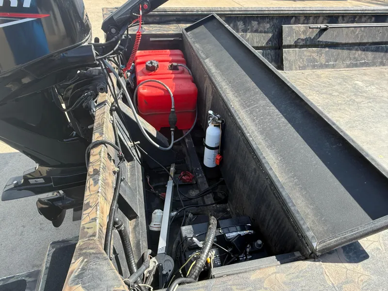 Slide: The Image of 2022 Lowe Roughneck RX2070 Tiller boat interior with red fuel tank and fire extinguisher. - 11