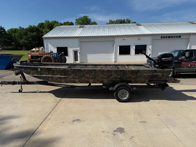 Slide: The Image of 2022 Lowe Roughneck RX2070 Tiller boat on trailer outside showroom. - 4
