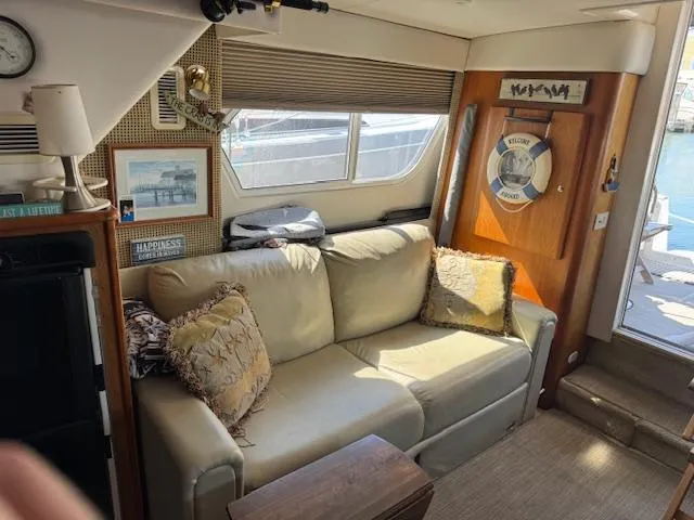 Slide: The Image of Interior of 2001 Silverton 35 Convertible yacht with beige sofa and nautical decor. - 15