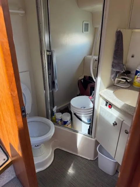 Slide: The Image of Bathroom interior of 2001 Silverton 35 Convertible boat, featuring toilet and shower. - 17