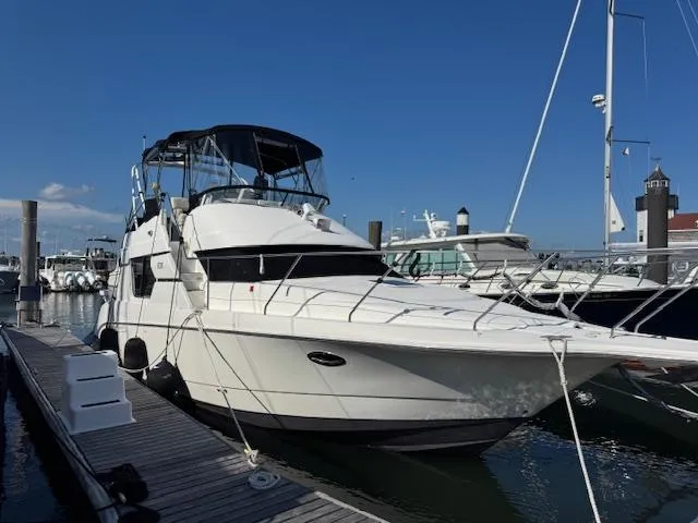 Slide: The Image of 2001 Silverton 35 Convertible yacht docked at marina under clear blue sky. - 3