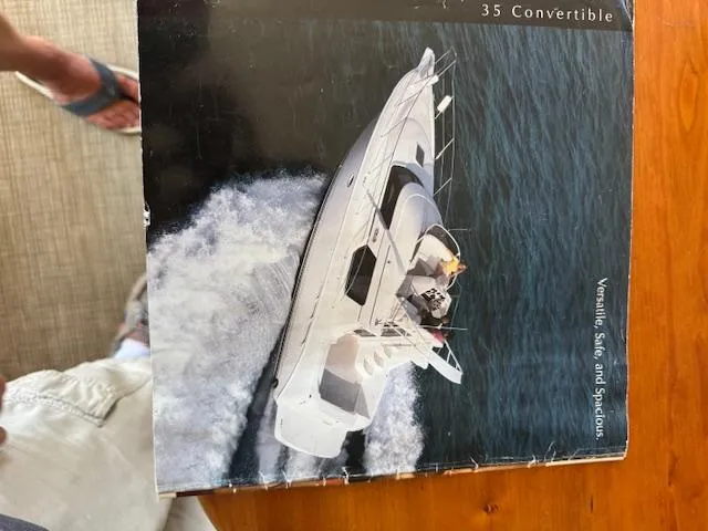 Slide: The Image of 2001 Silverton 35 Convertible yacht cruising on open water. - 4