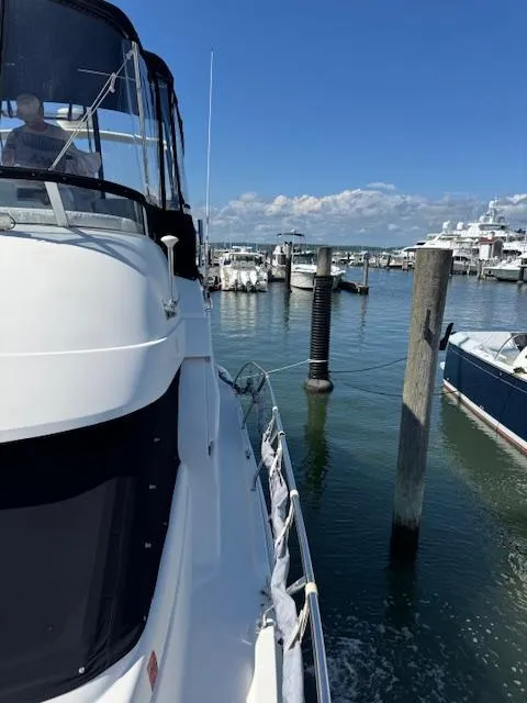 Slide: The Image of 2001 Silverton 35 Convertible yacht docked at a marina under a clear blue sky. - 7
