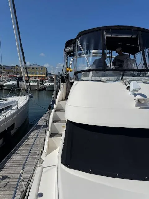 Slide: The Image of 2001 Silverton 35 Convertible yacht docked at marina under clear blue sky. - 8
