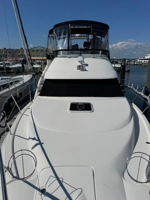 Slide: The Image of 2001 Silverton 35 Convertible yacht docked at marina under clear blue sky. - 9