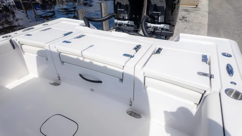 Slide: The Image of 2025 Tidewater 3100 Carolina Bay boat with dual outboard engines and storage compartments. - 10