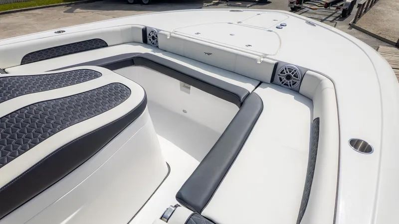 Slide: The Image of 2025 Tidewater 3100 Carolina Bay boat interior with cushioned seating and speaker system. - 18