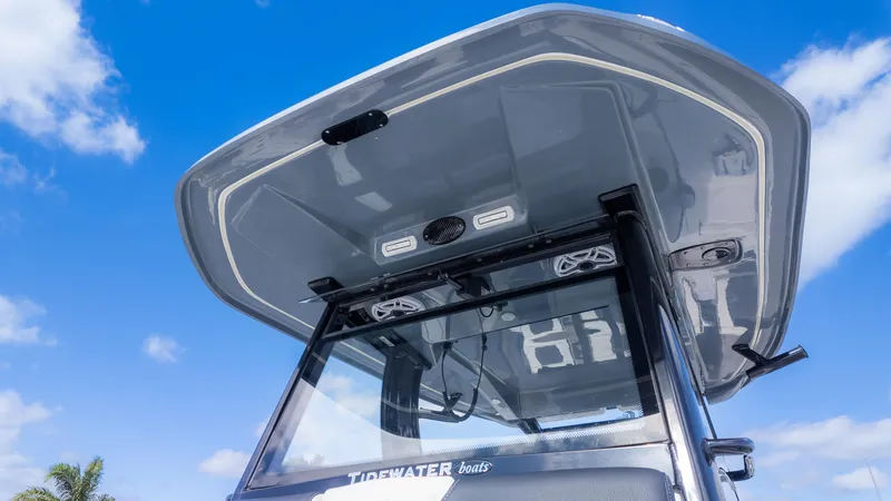Slide: The Image of 2025 Tidewater 3100 Carolina Bay boat with sleek design under clear blue sky. - 20