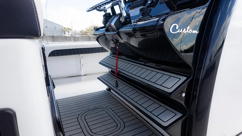 Slide: The Image of 2025 Tidewater 3100 Carolina Bay boat interior with custom black steps and sleek design. - 25
