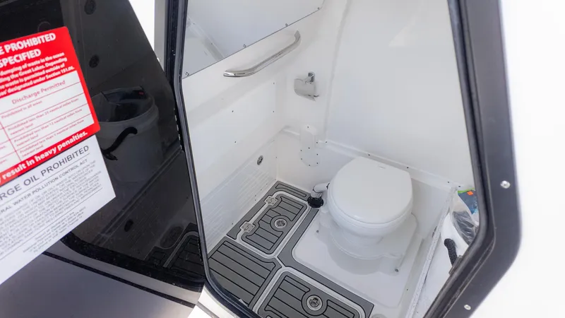 Slide: The Image of 2025 Tidewater 3100 Carolina Bay boat interior with compact marine toilet. - 26