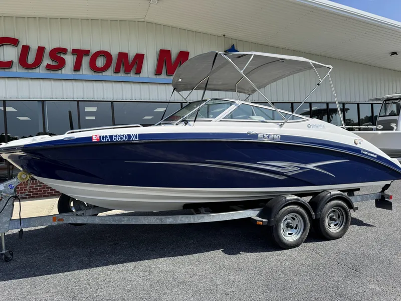 Slide: The Image of 2012 Yamaha Boats SX210 on trailer outside dealership. - 12