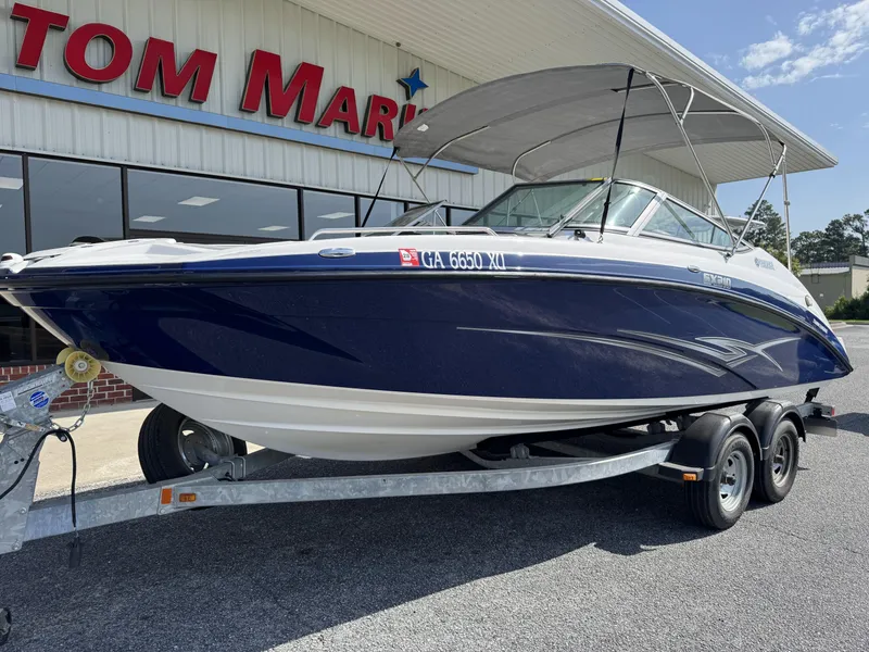 Slide: The Image of 2012 Yamaha SX210 boat on trailer outside dealership. - 13