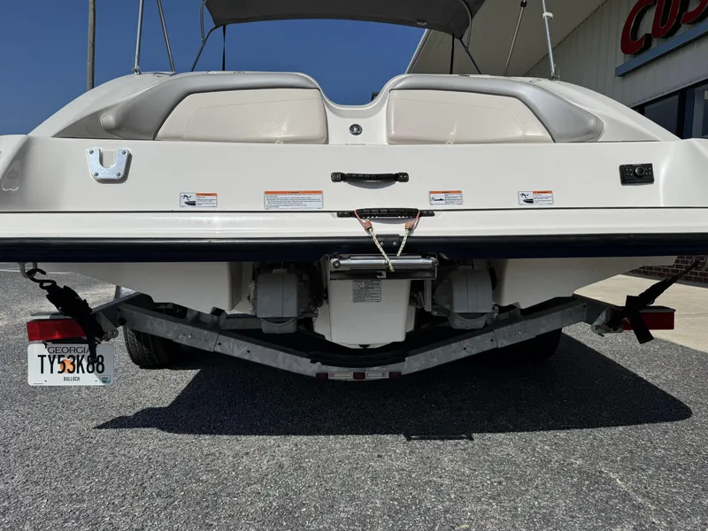 Slide: The Image of Rear view of a 2012 Yamaha Boats SX210 on a trailer, parked outdoors. - 5