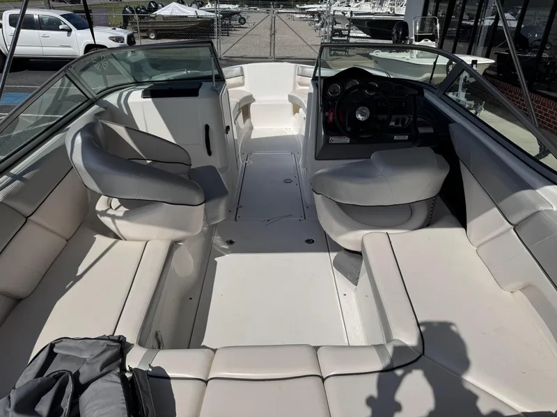 Slide: The Image of 2012 Yamaha Boats SX210 interior with white seating and steering console. - 6