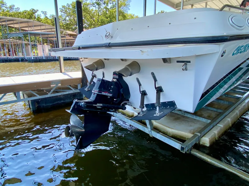 Slide: The Image of 1999 Checkmate 259 Convincer boat with MerCruiser outdrive, docked on a sunny day. - 11
