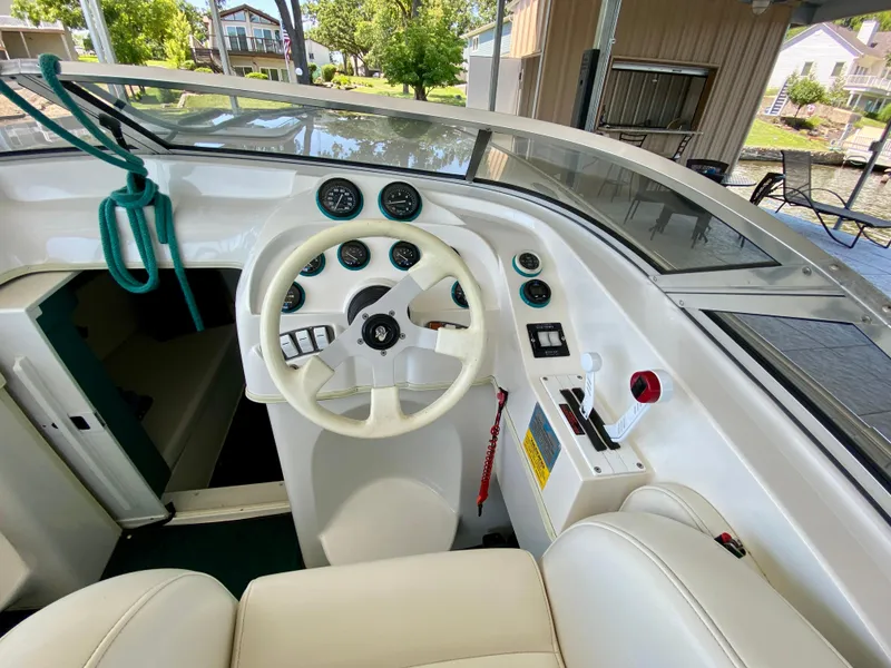 Slide: The Image of Interior view of 1999 Checkmate 259 Convincer boat cockpit with steering wheel and controls. - 12