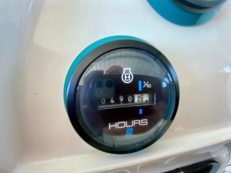 Slide: The Image of Hour meter on 1999 Checkmate 259 Convincer boat showing 490.2 hours. - 14