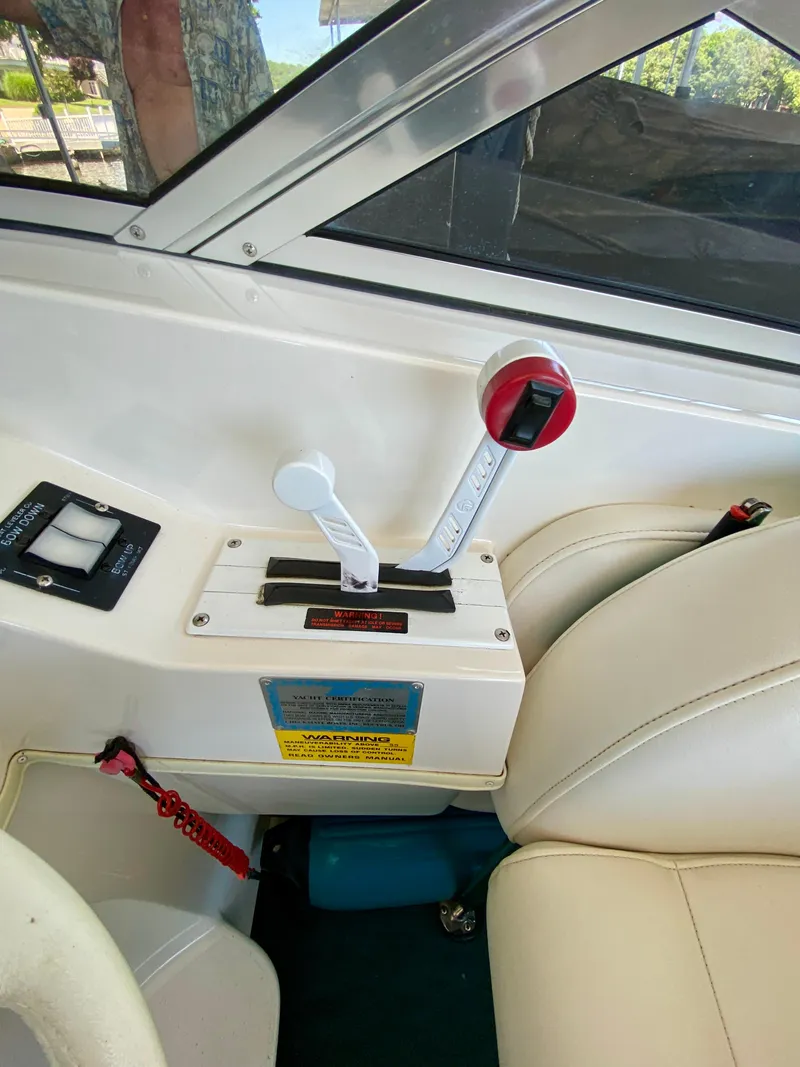 Slide: The Image of 1999 Checkmate 259 Convincer boat interior with throttle controls and beige seating. - 16