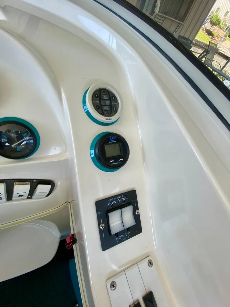 Slide: The Image of 1999 Checkmate 259 Convincer boat dashboard with controls and gauges. - 17
