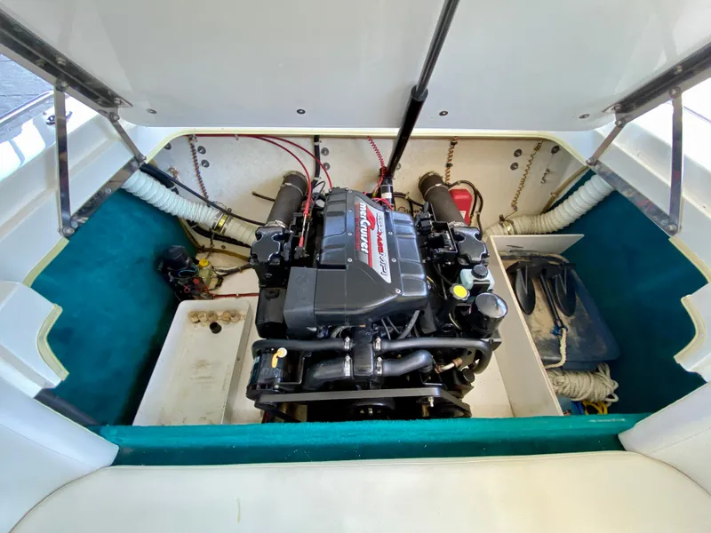 Slide: The Image of 1999 Checkmate 259 Convincer engine compartment with MerCruiser engine, open hatch view. - 22