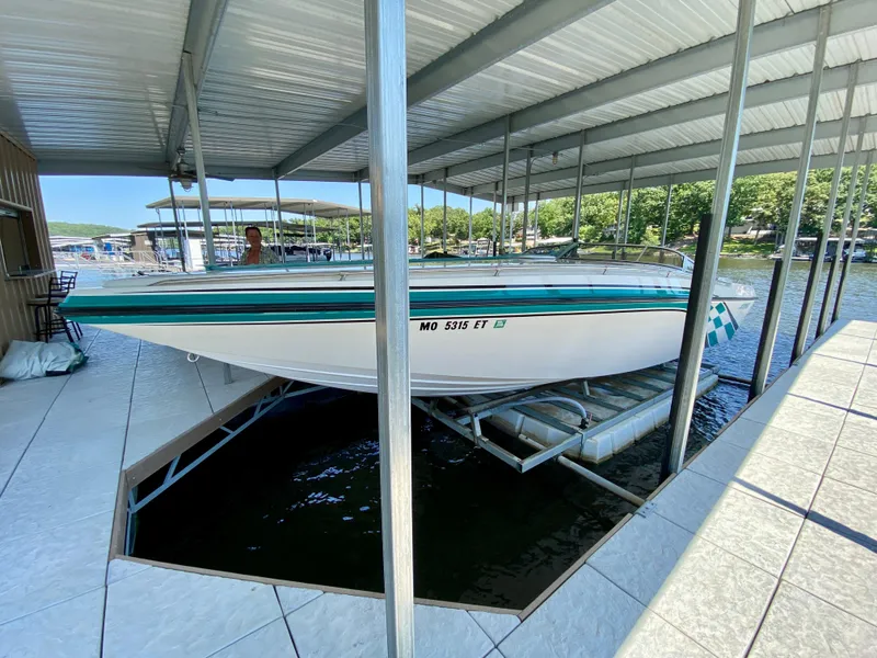 Slide: The Image of 1999 Checkmate 259 Convincer boat docked in covered marina, side view. - 3
