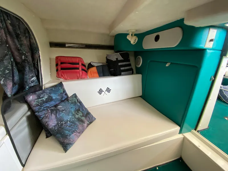 Slide: The Image of 1999 Checkmate 259 Convincer cabin interior with cushions and life jackets. - 30