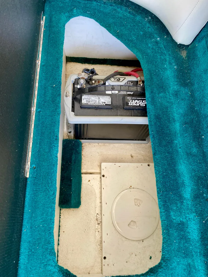 Slide: The Image of Battery compartment of 1999 Checkmate 259 Convincer boat with teal carpet. - 31