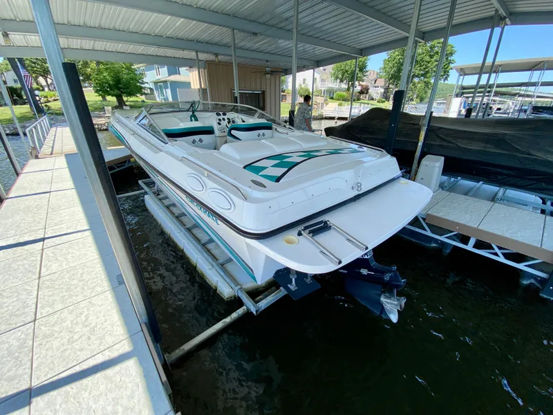 Slide: The Image of 1999 Checkmate 259 Convincer boat docked under a covered marina. - 4