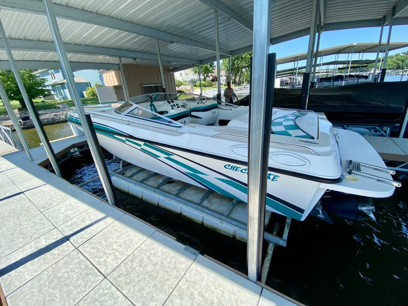 Slide: The Image of 1999 Checkmate 259 Convincer boat docked under covered marina. - 5